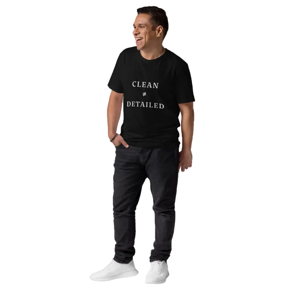 Man wearing a black t-shirt with 'Clean & Detailed' text, dark pants, and white shoes on a white background