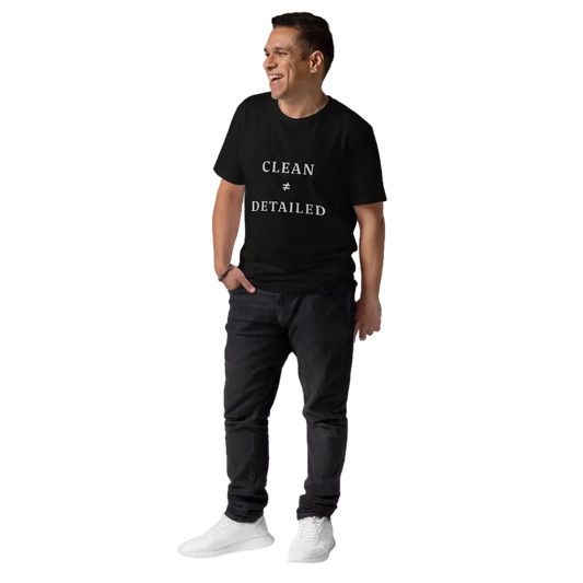 Man wearing a black t-shirt with 'Clean & Detailed' text, dark pants, and white shoes on a white background